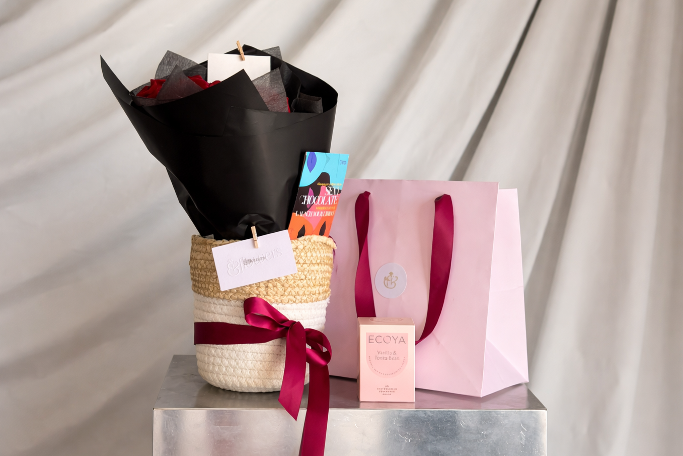 New Flame - The perfect gift basket for Valentine's Day or any special occasion. 10 red roses alongside a functional chocolate (Sexy for libido or Rhythm for PMS) from Finest and Friends and an Ecoya candle. The perfect flame for your new or old flame!